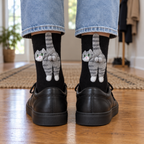 Back of adult ankles in black socks with 3D gray tabby cats