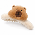 Fluffy cream claw clip with a plush capybara face on a white background