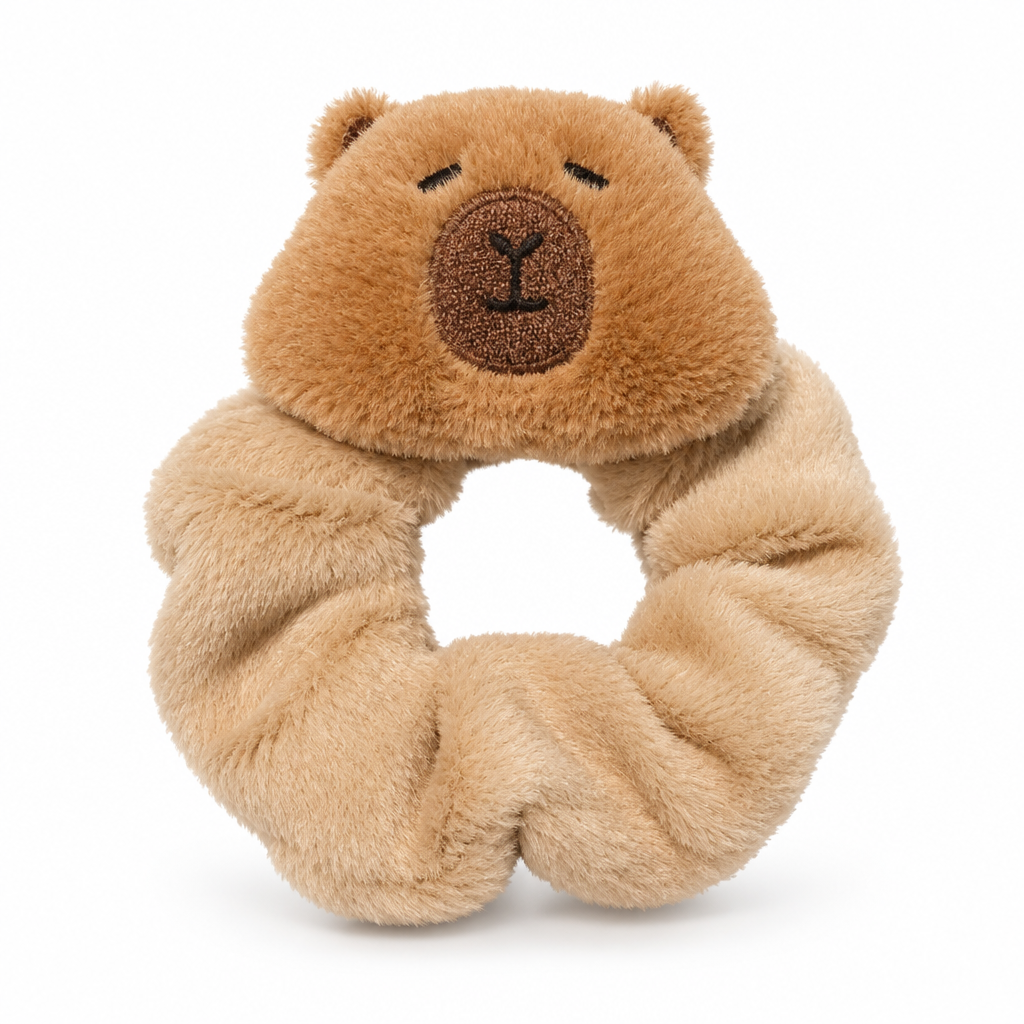 Beige plush scrunchie with a capybara face on a white background