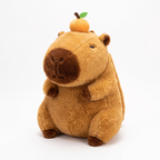 Fluffy standing capybara plush backpack with a mandarin on its head on a white background