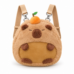 Round capybara plush backpack with a golden belly patch on a white background