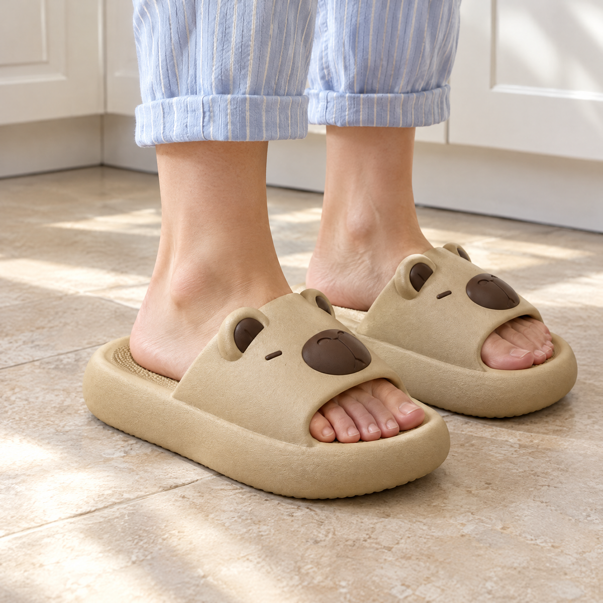 Beige Capybara Slide Sandals worn barefoot on a kitchen floor in morning light