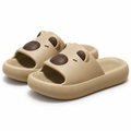 Beige capybara face slide sandals on a white background
