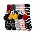 Five pairs of crew socks with cats peeking out at the ankle on a white background