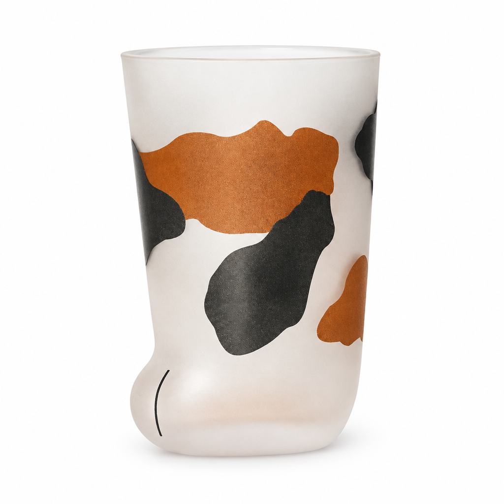 Frosted cat paw glass cup with calico patches on a white background