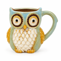 Sage green and blue ceramic owl mug on a white background