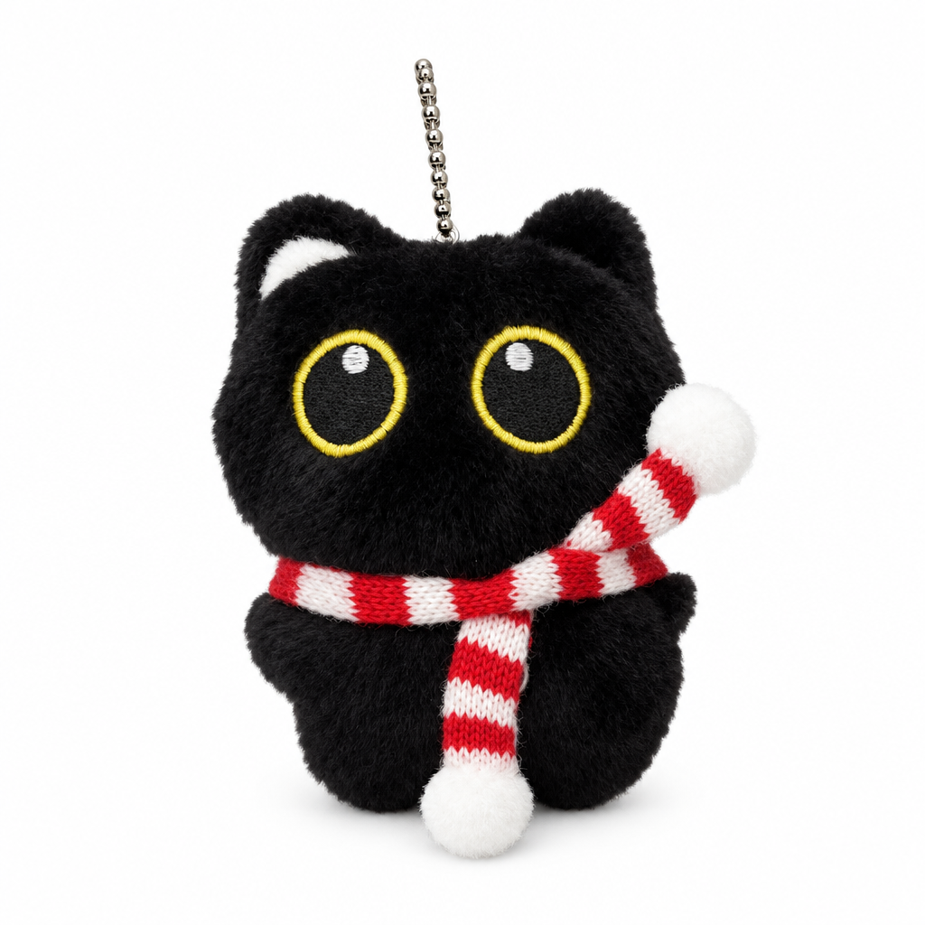Fluffy black cat keychain with a red and white striped scarf on a white background