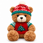 Brown teddy bear in a red Christmas tree sweater and knit beanie on a white background