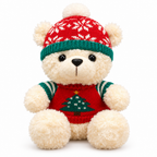Cream teddy bear in a red Christmas tree sweater and knit beanie on a white background