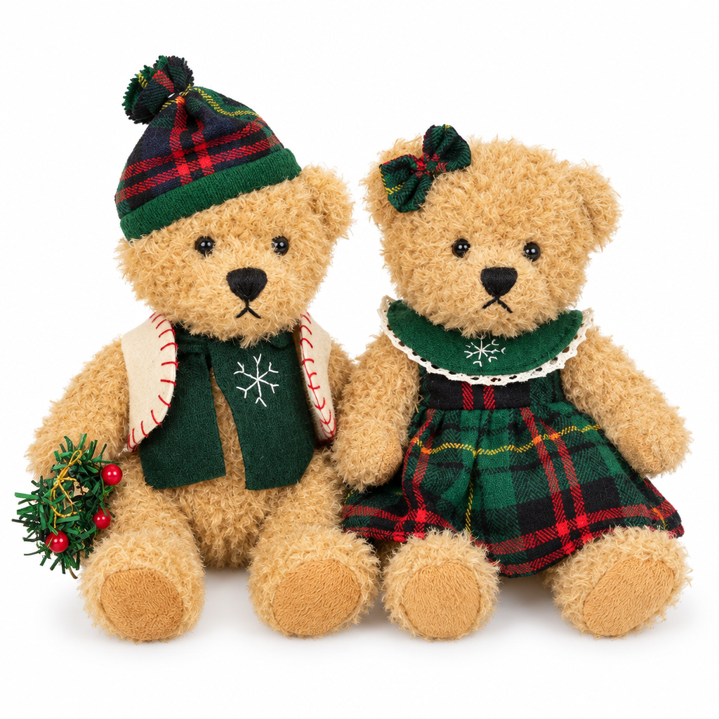 Two teddy bears in a tartan beanie and a green tartan dress on a white background