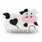 Cow-shaped hair claw clip with heart spots and pink muzzle on a white background