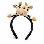 Black headband with a small smiling plush cow on top, on a white background