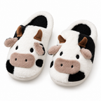 Black and white cow face plush slippers on a white background