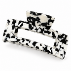 Rectangular open-frame cow print claw clip on a white background