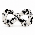Bow-shaped cow print claw clip on a white background