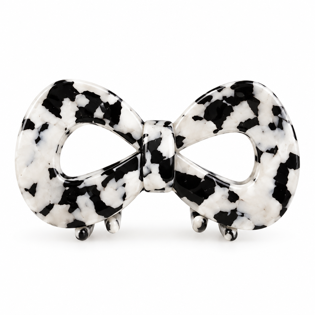 Bow-shaped cow print claw clip on a white background