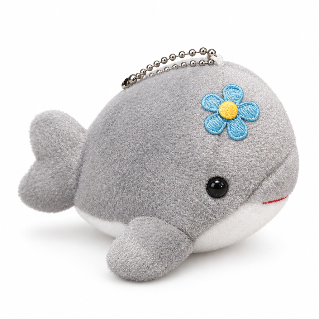 Gray plush dolphin keychain with a blue flower on a white background