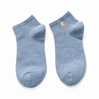 Light blue ankle socks with a small embroidered bird on a white background