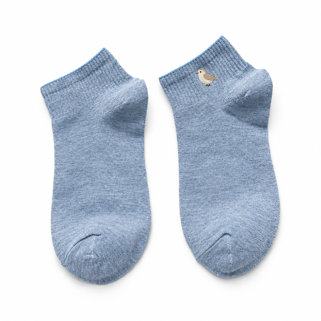 Light blue ankle socks with a small embroidered bird on a white background