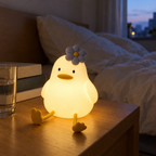 Duck night light glowing warm on a nightstand in a dim bedroom