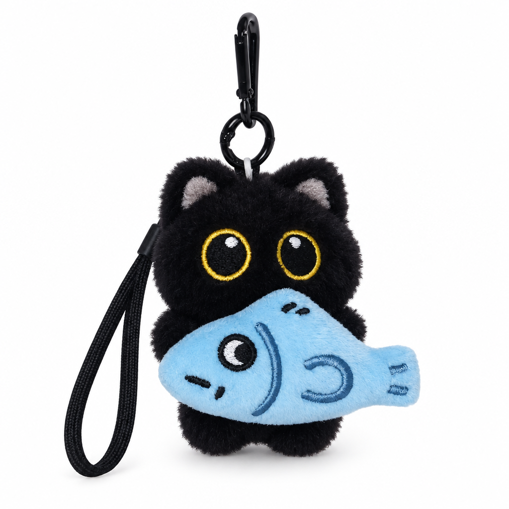 Black cat plush bag charm holding a blue fish on a white background