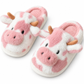 White fluffy cow slide slippers with pink patches on a white background