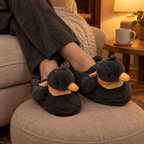 Black Fluffy Duck Slippers worn with ankles crossed on a footstool in warm lamp light