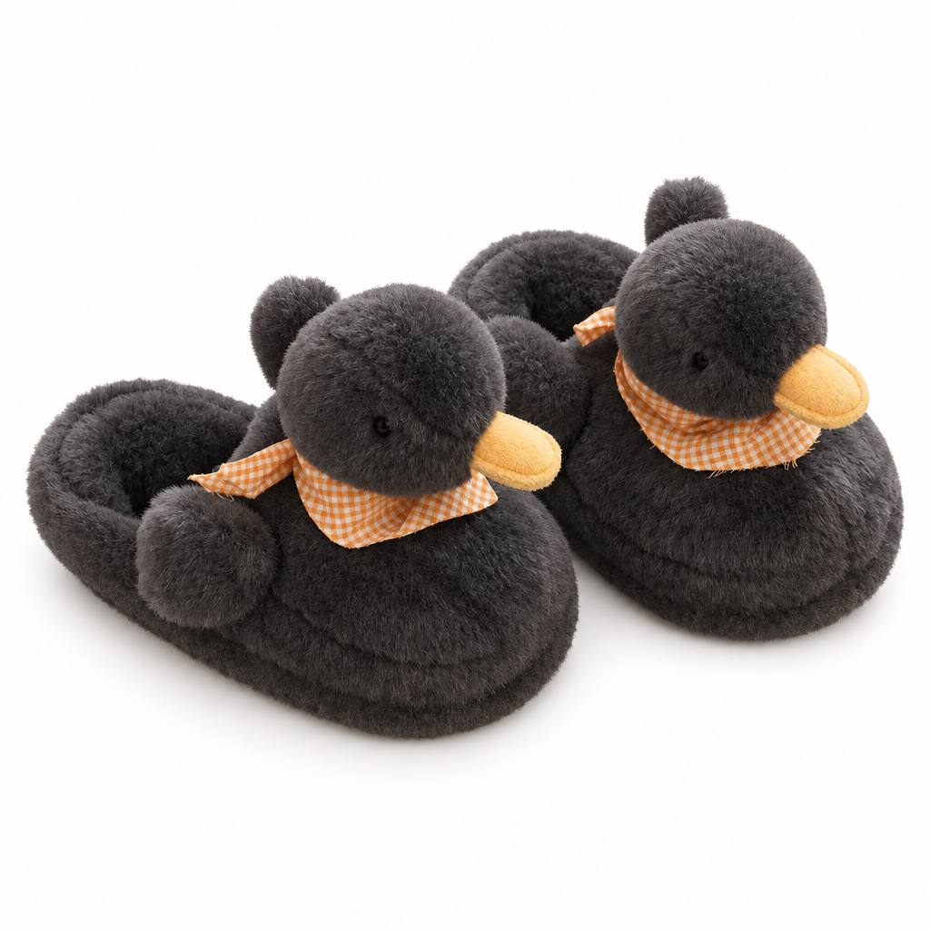 Pair of fluffy black duck slippers with orange scarves on a white background
