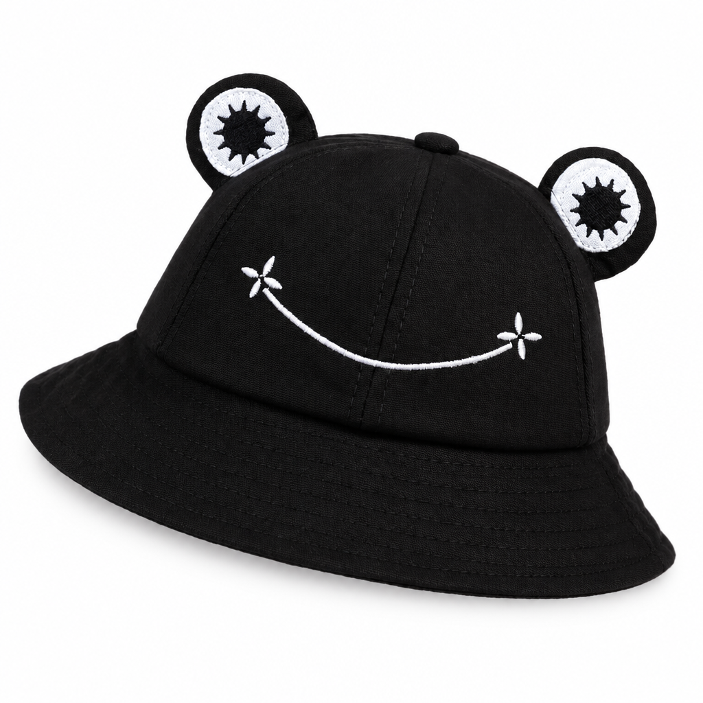 Black frog bucket hat with padded eyes and a white embroidered smile on a white background