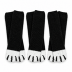 Three pairs of black fuzzy cat paw socks on a white background