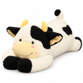 Giant cream cow plush with black spots lying on its belly on a white background