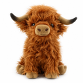 Shaggy ginger-brown highland cow plush with curved horns on a white background