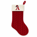Red knit Christmas stocking with an embroidered letter A on the cuff on a white background