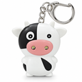 Cartoon cow LED keychain with a pink muzzle on a white background