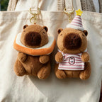 Toasty and Bday Happy Capy keychain plushies clipped to a canvas tote bag