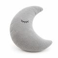 Gray crescent moon plush pillow with a sleepy face on a white background