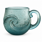 Sea green glass mug with a curling ocean wave in relief on a white background
