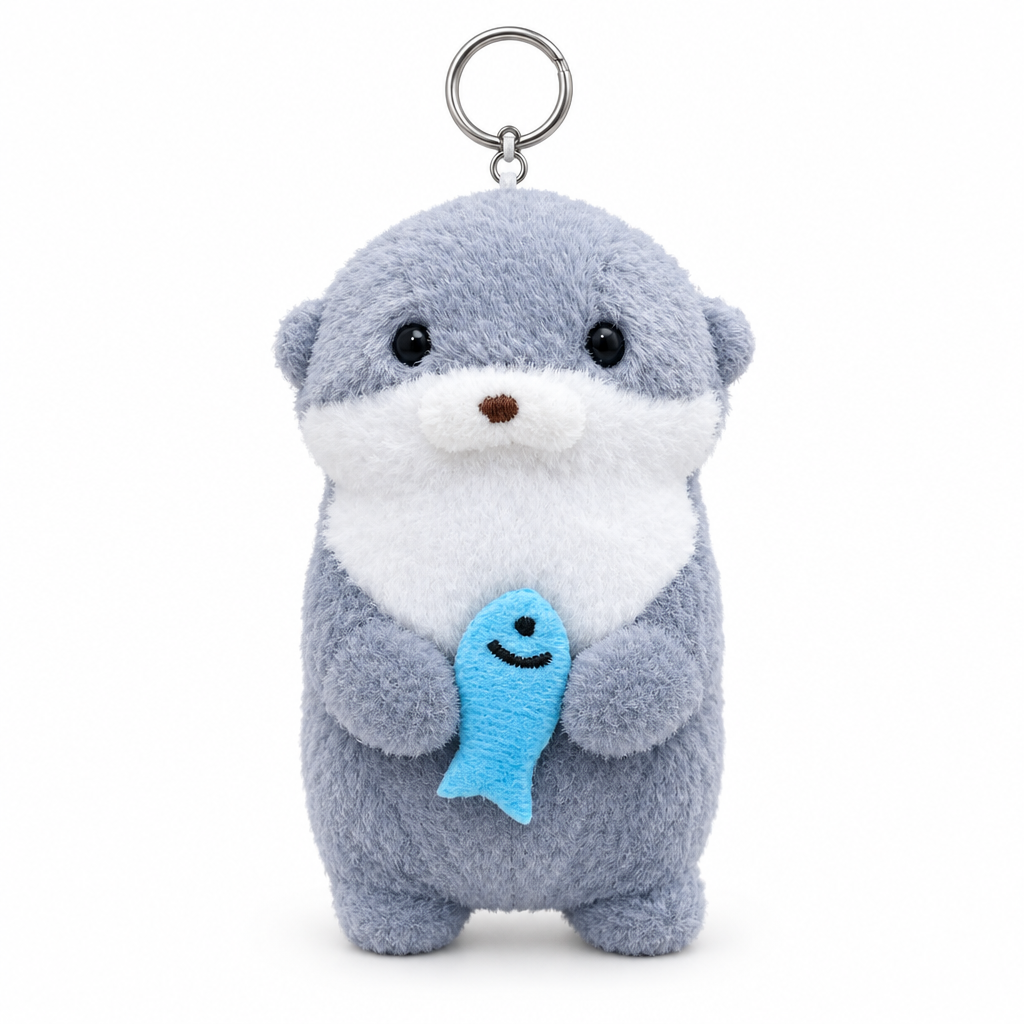 Blue gray otter plush keychain hugging a blue fish on a white background