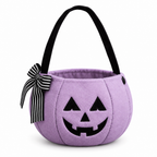 Lilac plush pumpkin bucket bag with a jack-o'-lantern face and striped bow on a white background