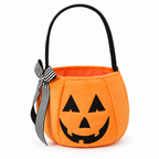 Orange plush pumpkin bucket bag with a jack-o'-lantern face and striped bow on a white background