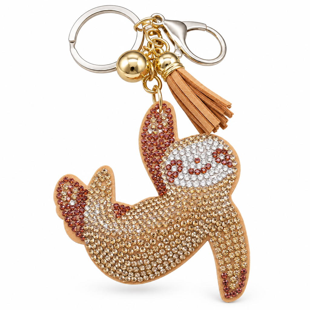 Rhinestone sloth keychain with a keyring, gold bead and tan tassel on a white background