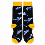 Black crew socks with blue-gray sharks and yellow trim on a white background