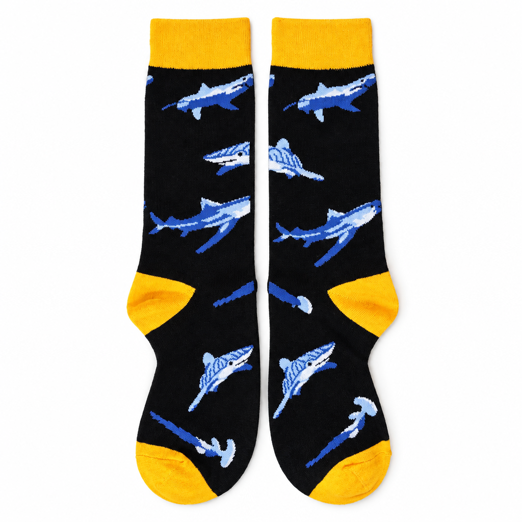 Black crew socks with blue-gray sharks and yellow trim on a white background