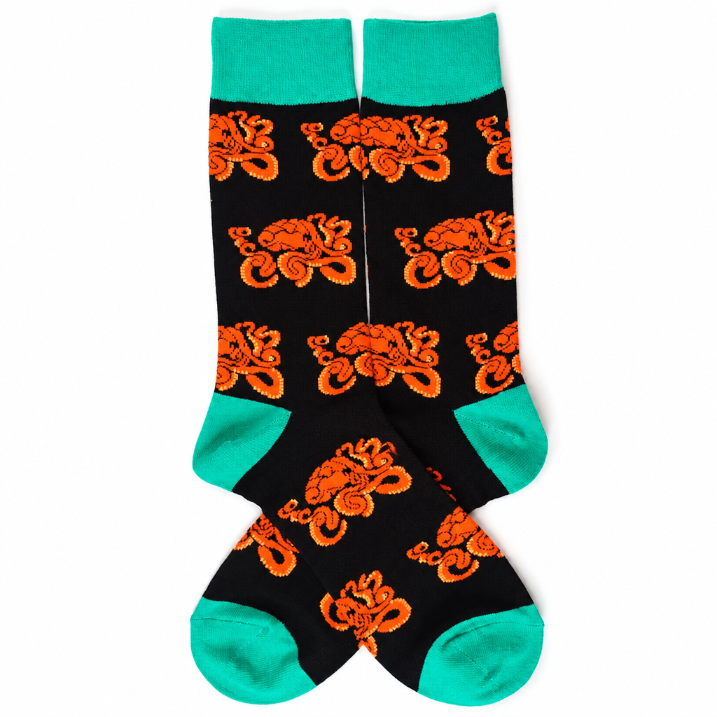 Black crew socks with orange octopuses and mint trim on a white background