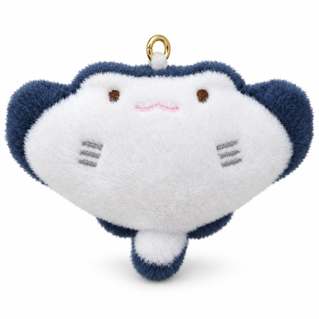 White and navy manta ray plush keychain on a white background