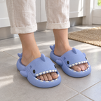 Blue Shark Slide Sandals worn barefoot on a kitchen floor in morning light