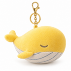 Yellow whale plush keychain with a gold-tone clasp on a white background