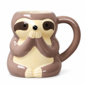 Sloth-shaped ceramic mug with paws over its mouth on a white background