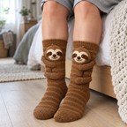 Adult feet in brown knit socks with a 3D sloth hugging each leg