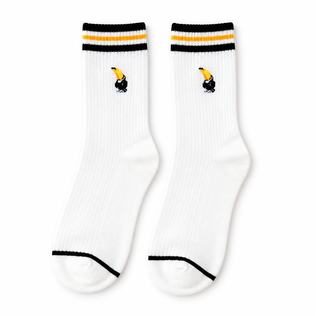 White socks with black and yellow striped cuffs and an embroidered toucan on a white background